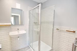 a bathroom with a glass shower and a sink at CarterCo Rooms in Portsmouth