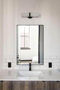 a bathroom with a sink and a mirror at ROOST Cleveland in Cleveland +40 photos