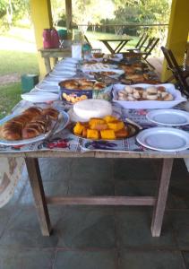 a table with many plates of food on it at Pousada Bela Vista in Conceição da Ibitipoca