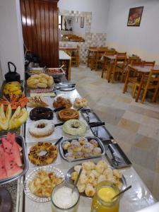 a buffet with many different types of food on a table at Pousada Maciel in São Thomé das Letras