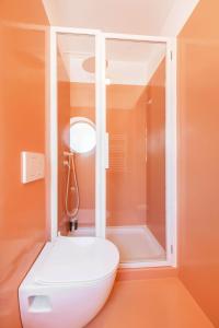 a white toilet in a bathroom with a shower at Jardim Suites by Olala Homes in Cascais