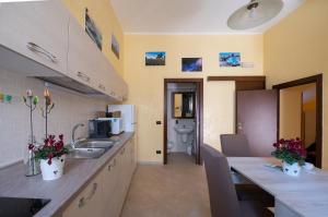 a kitchen with a sink and a toilet in a room at La casa di Alice in Cisternino