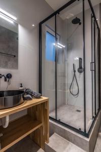 a bathroom with a glass shower and a sink at Historic Center Apartment 3 in Athens