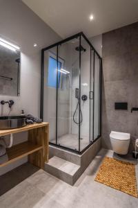 a bathroom with a shower with a toilet and a sink at Historic Center Apartment 3 in Athens
