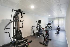 a gym with treadmills and exercise bikes in a room at Résidence Nemea Aix Campus 2 in Aix-en-Provence +8 photos