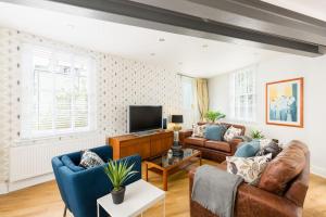 a living room with two couches and a tv at The Old Morgan Period Town House in Great Malvern