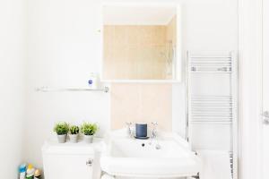 a white bathroom with a sink and a toilet at The Old Morgan Period Town House in Great Malvern +15 photos