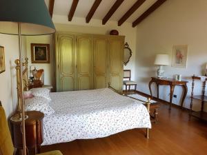 a bedroom with a bed and a yellow cabinet at B&B La Casaccia in Verbania