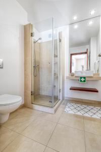 a bathroom with a shower and a toilet and a sink at Casa Rosa in Fabulous Portimão in Portimão