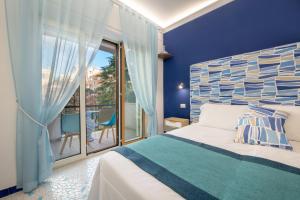 a blue bedroom with a bed and a balcony at Aquae Romanae Piazza Lauro in Sorrento