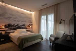 a hotel room with a bed and a window at Senhora da Rosa, Tradition & Nature Hotel in Ponta Delgada