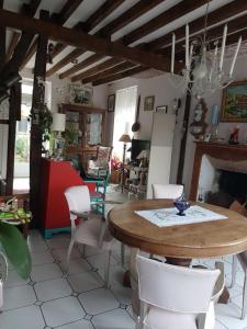 a dining room with a table and chairs at Lecerf in Condé-sur-Noireau