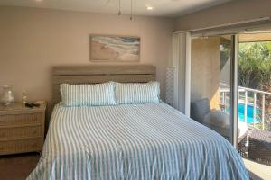 萨拉索塔Condo with Pool Access Less Than 4 Miles to Siesta Key Beach的一间卧室配有一张带条纹床罩的床 更多17张照片