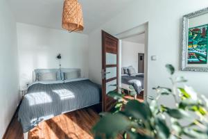 a bedroom with a bed and a mirror at Apartmány CAFÉ-CAFÉ in Jičín