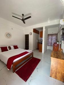 a bedroom with a bed and a ceiling fan at DOLPHIN ENCLAVE SERVICE STUDIO APARTMENTS in Kalpetta