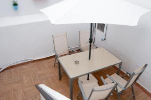 a meeting room with a white table and chairs at Urban Suites in Las Palmas de Gran Canaria