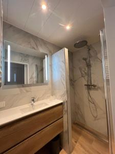 a bathroom with a sink and a shower at SEA YOU Hotel Noordwijk in Noordwijk aan Zee