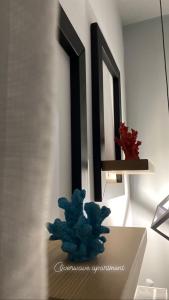a blue plant sitting on a table in a room at Overwave Apartment in Kavála