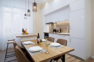 een eetkamer met een tafel en stoelen en een keuken bij Grand Munz in Pula