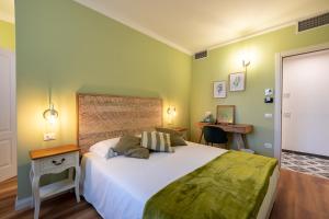 sypialnia z dużym białym łóżkiem i biurkiem w obiekcie B&B Follonica w mieście Follonica