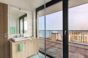 a bathroom with a sink and a view of the ocean at MF Lux Penthouse in Siófok
