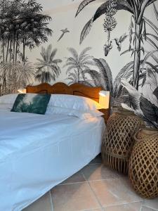 a bedroom with a bed with palm trees on the wall at Villa Paradis in Les Issambres