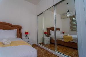 a bedroom with a mirror and a bed in it at Metin Houses in Kyrenia