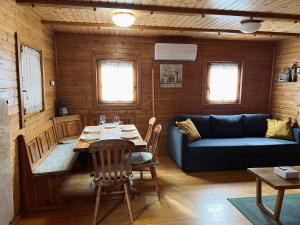 a living room with a table and a couch at Hiška Marjetica in Podčetrtek