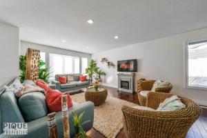a living room with a couch and chairs at Tropical Oasis - King Beds - Free Netflix & Parking - Fast Wi-Fi in Edmonton
