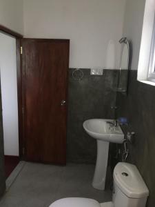 a bathroom with a toilet and a sink at BAWANS VILLA Holiday Home for Family or Group in Hikkaduwa