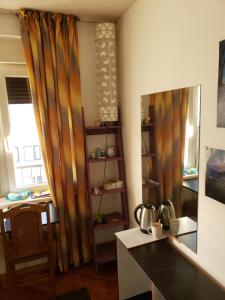 a kitchen with curtains and a table and a window at Cozy room in appartment, with shared bathroom,downtown Belgrade in Belgrade