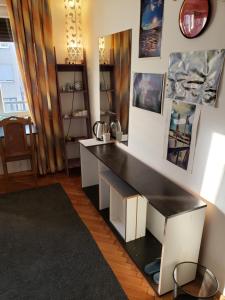 a desk in a room with a black counter at Cozy room in appartment, with shared bathroom,downtown Belgrade in Belgrade +4 photos