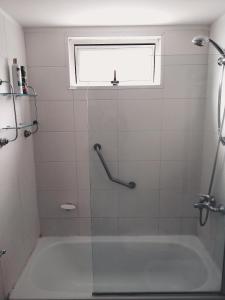 a bathroom with a bath tub with a window at Palermo Deluxe Apartment in Buenos Aires