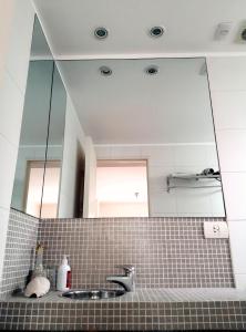 a bathroom with a sink and a large mirror at Palermo Deluxe Apartment in Buenos Aires