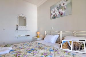 a bedroom with a bed with a picture on it at Villa Meli Afionas Corfu in Afionas