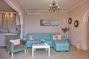 a living room with a blue couch and a table at Villa Meli Afionas Corfu in Afionas