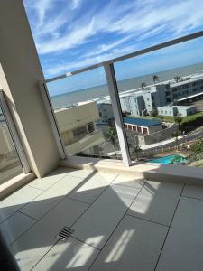 a balcony with a view of the beach and buildings at 201 St Tropez, South Coast in Margate