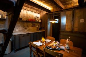 a kitchen with a wooden table with food on it at B&B In den Wijde Koe in Maassluis