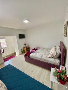 a bedroom with a bed and a couch in it at JOCKER in Virpazar