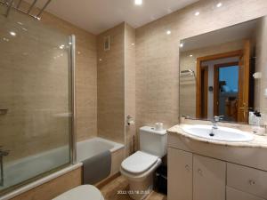 a bathroom with a toilet and a sink and a shower at LG Calafell Beach in Calafell