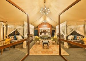 a bedroom in a tent with two beds and a table at Tribe Yala - Luxury Camping in Yala