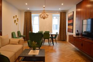 a living room with a couch and a dining room at New City Center Stays 2 in Munich