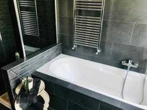 a bathroom with a bath tub and a sink at Carolina’S Nest in Casal Palocco +15 photos