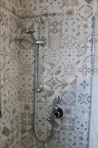 a shower with a glass door in a bathroom at Sea & Sun - Guest House in Bisceglie