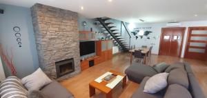 a living room with a couch and a fireplace at Villa castelló salou in Salou