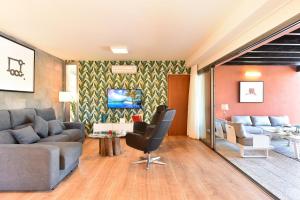 a living room with a couch and a table at Par 4 Blue Star by VillaGranCanaria in La Playa de Arguineguín
