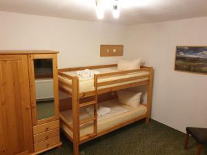 a room with a bunk bed and a mirror at guesthouse Elbsandstein Appartement Lilienstein in Rathmannsdorf