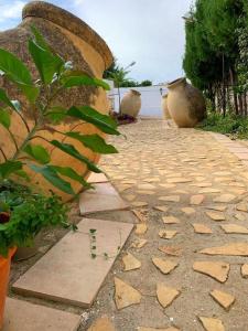 a stone walkway with plants on the side of it at Hostal El Castillo Alcala De Guadaira in Alcalá de Guadaira +13 photos
