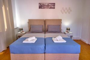 a bedroom with a bed with two pillows on it at Villa Christine Afionas Corfu in Afionas