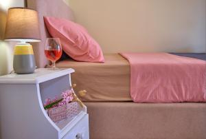 a bedroom with a bed and a glass of wine at Villa Christine Afionas Corfu in Afionas